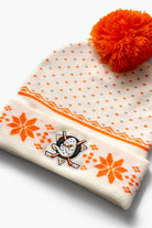 Close-up of Anaheim Ducks primary logo on a beanie with orange pom-pom and snowflake pattern on a white background